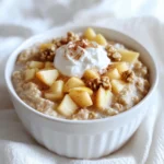 - 1 cup rolled oats - 1 ½ cups unsweetened almond milk (or milk of choice) - 1 medium apple (peeled, cored, and diced) - 1 tablespoon maple syrup (or honey) - 1 tablespoon chia seeds - ½ teaspoon cinnamon - ¼ teaspoon nutmeg - 1 tablespoon walnuts, chopped (optional) - 2 tablespoons Greek yogurt (optional for topping) - Mixing bowl - Mason jar or airtight container - Microwave (optional) The main ingredients in this recipe are simple yet effective. The rolled oats form the base, offering a hearty texture. Almond milk adds creaminess but feel free to use any milk you prefer. The apple brings natural sweetness, while maple syrup enhances that flavor. Chia seeds add healthy fats and help thicken the mix. For optional ingredients, spices like cinnamon and nutmeg give a warm, cozy feel. Chopped walnuts can add a nice crunch, and Greek yogurt is great for creaminess. You need a mixing bowl for combining the ingredients. A mason jar or airtight container is perfect for soaking them overnight. A microwave is handy if you want to warm your oats in the morning. This recipe is flexible. You can adjust it to fit your taste. Enjoy making it your own! Start with a mixing bowl. Combine 1 cup of rolled oats, 1 ½ cups of unsweetened almond milk, and 1 tablespoon of chia seeds. Add 1 tablespoon of maple syrup and ½ teaspoon of cinnamon. Sprinkle in ¼ teaspoon of nutmeg. Stir well until all ingredients mix evenly. This gives the oats great flavor and creaminess. Now, take your medium apple. Peel, core, and dice it. Gently fold the diced apple into the oat mixture. This helps the apple flavors blend into the oats. Be careful not to mash the apple pieces. You want them to stay whole for texture. Transfer the oat mixture into a mason jar or an airtight container. Seal it tightly and refrigerate overnight. Soaking allows the oats to soften and absorb the liquid. This makes the oats creamy and easy to digest. In the morning, take the container out of the fridge. If you want to warm them, place the oats in the microwave for about 1-2 minutes. Stir well after heating. Top with chopped walnuts for a nice crunch and 2 tablespoons of Greek yogurt for creaminess. Finish with a sprinkle of cinnamon. Enjoy your warm apple pie oats right away! Choosing the best type of oats is key. I recommend rolled oats for their texture. They soak up liquid well and create a creamy base. Quick oats can turn mushy, while steel-cut oats need longer soaking. Balancing sweetness and spice makes your oats shine. I use maple syrup for a natural sweetness and add cinnamon and nutmeg to mimic apple pie flavors. Adjust these amounts to suit your taste. If you prefer it sweeter, add more maple syrup or honey. Over-soaking your oats leads to a mushy mess. Aim for 8 hours of soaking for the best texture. If you soak them too long, they can lose their bite. When switching ingredients, consider the ratios. For example, if you swap almond milk for dairy milk, the taste changes. Make sure to adjust the sweetness if you use sweetened milk. Adding protein or fiber-rich ingredients boosts the health factor. Greek yogurt is a great topping choice. It adds creaminess and protein. You can also mix in some nut butter for healthy fats and protein. To make it more filling, add chia seeds or nuts. Chia seeds expand and help you feel full longer. Walnuts give a nice crunch and healthy omega-3s. These small changes can make your breakfast more satisfying and nutritious. {{image_2}} You can switch apples for other fruits in this recipe. Try using pears for a sweet twist. Berries add a nice tartness. Bananas bring a creamy texture and natural sweetness. Each option gives a unique flavor. Mix and match to find your favorite. Spices can change the taste of your oats. Use pumpkin pie spice for a cozy fall flavor. Adding vanilla extract gives the oats a warm, sweet aroma. Experiment with different spice blends to find what you love best. This recipe can fit many diets. For a vegan option, use plant-based milk and skip the yogurt. For gluten-free oats, choose certified gluten-free rolled oats. These changes keep the dish tasty while meeting your needs. To keep your warm apple pie overnight oats fresh, store them in the fridge. Use an airtight container or a mason jar. This helps to keep the oats moist and tasty. Make sure the lid is on tight. You can also layer toppings separately to keep them fresh. These oats last about 3 to 5 days in the fridge. However, the sooner you eat them, the better they taste! If you notice any strange smells or colors, it’s best to toss them out. Fresh is always best! You can freeze your oats for later, too! Prepare them as usual and put them in freezer-safe containers. Leave some space at the top to avoid spills as they freeze. When ready to eat, thaw them in the fridge overnight. You can warm them up in the microwave or on the stove. Enjoy a quick and tasty breakfast anytime! Yes, you can make warm apple pie overnight oats ahead of time. This recipe is perfect for meal prepping. You can prepare several jars and store them in the fridge. The oats will stay fresh for up to five days. This way, you have a tasty breakfast ready to go each morning. Just grab a jar, warm it up, and enjoy! If you need a substitute for almond milk, there are many options. You can use regular cow's milk or any plant-based milk. Some good alternatives are oat milk, soy milk, or coconut milk. Each option has its own taste. Choose what works best for your diet or flavor preference. You can warm the overnight oats on the stovetop. Just pour the oats into a small pot. Heat over low to medium heat, stirring often. This method takes a bit longer, but it warms the oats nicely. You can also add a splash of milk to help heat them evenly. Another option is to use a double boiler. Yes, this recipe is very kid-friendly! Kids love the sweet taste of apples and cinnamon. Plus, it has a creamy texture from the oats and yogurt. The oats are also healthy, full of fiber, and keep them full. You can even let them help mix the ingredients. This makes breakfast fun and tasty for everyone! Warm apple pie overnight oats are easy to make and delicious. We covered the key ingredients, from rolled oats to apple choices. You can boost flavor with spices or nuts. Preparing them is as simple as mixing and letting them soak overnight. We also explored common mistakes and tips to enhance nutrition. In your kitchen, you can create tasty, healthy meals. Remember, overnight oats offer flexibility in flavors and ingredients. Enjoy your warm apple pie overnight oats any time!