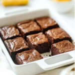 To make these vegan pumpkin brownies, gather these four simple ingredients: - 1 cup canned pumpkin puree - 1 cup almond butter (or any nut/seed butter) - 1/2 cup maple syrup - 1 cup cacao powder These ingredients come together to create a rich and tasty treat. Each ingredient plays a key role in both flavor and nutrition. - Pumpkin puree is low in calories but high in fiber. It adds moisture and a subtle sweetness. - Almond butter provides healthy fats and protein. It helps bind the brownies and adds creaminess. - Maple syrup is a natural sweetener. It offers minerals like manganese and zinc. - Cacao powder is rich in antioxidants. It gives the brownies a rich chocolate flavor without dairy. Together, these ingredients create a well-rounded dessert that feels indulgent yet healthy. Choosing the right ingredients makes a big difference. Here are some tips: - Canned pumpkin: Look for 100% pumpkin puree, not pumpkin pie filling. This ensures no added sugars or spices. - Nut/seed butter: Choose a butter without added sugars or oils for a pure flavor. Freshly ground options are often best. - Maple syrup: Opt for pure maple syrup, not imitation. Check the label for quality. - Cacao powder: Select unsweetened cacao for the best chocolate taste. Look for brands that are fair trade or organic for better quality. These tips help you get the most from your vegan pumpkin brownies. {{ingredient_image_1}} Start by preheating your oven to 350°F (175°C). This helps the brownies bake evenly. While the oven warms, line an 8-inch square baking pan with parchment paper. This step makes it easy to lift out the brownies later. Make sure the paper hangs over the sides a bit. This will help when you remove the brownies from the pan. In a large mixing bowl, add 1 cup of canned pumpkin puree. Next, add 1 cup of almond butter. Stir these until they blend into a smooth mix. Then, pour in 1/2 cup of maple syrup. Give it a good stir until everything is well mixed. Now, slowly sift in 1 cup of cacao powder. Mix this in until you have a thick, uniform batter. It should feel rich and chocolatey. Spread the batter into your prepared baking pan. Use a spatula to make the top even. Place the pan in the preheated oven. Bake for 25 to 30 minutes. To check if they are done, insert a toothpick into the center. If it comes out mostly clean, they are ready. Let the brownies cool in the pan. Once cool, lift them out using the parchment paper and cut them into squares. Enjoy your tasty vegan brownies! To get the best texture in your vegan pumpkin brownies, use smooth almond butter. It helps create a creamy batter. Make sure to measure your ingredients correctly. Too much cacao powder can make the brownies dry. Use room temperature pumpkin puree for a smoother mix. When you bake, check for doneness with a toothpick. It should come out mostly clean for the perfect brownie. One big mistake is overmixing the batter. Mix just until combined for a fudgy texture. Avoid using old or expired ingredients. Fresh maple syrup and cacao powder give better flavor. Also, don't skip lining your pan with parchment paper. This step helps you remove the brownies easily and keeps them intact. A good mixing bowl is key for easy stirring. A spatula helps you spread the batter evenly. Use a whisk for mixing the wet ingredients well. An 8-inch square baking pan is perfect for this recipe. Lastly, a toothpick is a must for testing if the brownies are done. These tools make the baking process smooth and fun! Pro Tips Use Fresh Pumpkin: For a richer flavor, consider roasting your own pumpkin instead of using canned puree. This adds an extra depth of taste to your brownies. Check for Doneness: Ovens can vary in temperature, so keep an eye on your brownies. They should be set on the edges but slightly soft in the center when done. Chill for Better Texture: After cooling, refrigerate the brownies for a couple of hours. This will help them firm up, making them easier to cut and enhancing their fudgy texture. Experiment with Mix-Ins: Feel free to add vegan chocolate chips, nuts, or spices like cinnamon and nutmeg to customize your brownies and add different textures and flavors. {{image_2}} If you want gluten-free brownies, you’re in luck! The main ingredients here are naturally gluten-free. The cacao powder and pumpkin puree are safe for those with gluten issues. Just make sure to use certified gluten-free almond butter. This way, you ensure every bite is worry-free. You can jazz up these brownies with fun flavors. Try adding chopped nuts like walnuts or pecans for a nice crunch. You can also sprinkle in spices like cinnamon or nutmeg. These spices bring warmth and depth to the brownies. For a fun twist, stir in some dairy-free chocolate chips. They melt and create gooey pockets of chocolate. These brownies are tasty on their own, but you can make them even better. Serve them warm with a scoop of vegan ice cream. The cold ice cream contrasts with the warm brownie. For a sweet touch, drizzle some maple syrup over the top. You can also pair them with a hot cup of coffee or tea for a cozy treat. Enjoy these brownies at a party or as a simple dessert for yourself. To keep your vegan pumpkin brownies fresh, store them in an airtight container. You can place parchment paper between layers to avoid sticking. This method helps keep the brownies soft and moist. Always store them at room temperature for the best taste. If you live in a warm area, consider keeping them in the fridge. You can freeze these brownies for later enjoyment. First, cut the brownies into squares. Wrap each square tightly in plastic wrap. Then, place them in a freezer bag or container. This helps prevent freezer burn. When you want to eat them, just thaw at room temperature or heat them in the microwave for a few seconds. These brownies last about 4 to 5 days at room temperature. In the fridge, they stay fresh for up to a week. If you freeze them, they can last for about 3 months. Just remember to check for any signs of spoilage before enjoying them. Yes, you can substitute almond butter. You can use any nut or seed butter. Peanut butter works well if you enjoy its flavor. Sunflower seed butter is a great choice for nut-free diets. Just ensure it has a similar consistency to almond butter. This keeps the brownies moist and delicious. To make these brownies sweeter, you can add more maple syrup. Start with an extra tablespoon and taste. You can also mix in a bit of agave syrup or coconut sugar. Both options add sweetness without changing the texture. Adjust until you find the right balance for your taste. Yes, these brownies are perfect for kids! They are rich, tasty, and packed with nutrients. The pumpkin adds fiber and vitamins, while the cacao provides antioxidants. Kids will love the chocolatey flavor. Plus, they are easy to make together as a fun kitchen project! Yes, you can use fresh pumpkin. Just cook it until soft, then mash it. Make sure to drain any excess water to keep the brownies from being too wet. Fresh pumpkin gives a lovely flavor. It might require a little more work, but the taste is worth it! In this article, we explored the key ingredients for delicious brownies and their nutritional benefits. I shared step-by-step instructions for mixing, baking, and achieving the right texture. Tips and tricks helped you avoid common mistakes and highlighted the tools needed for success. We also discussed variations like gluten-free options and serving ideas. Finally, I covered storage tips to keep your brownies fresh. Baking brownies can be simple and fun. With the right guidance, you can enjoy tasty treats anytime. Happy baking!