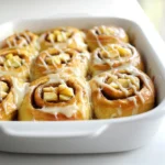 - 2 cans (16.5 oz each) refrigerated cinnamon rolls - 3 medium apples, peeled and chopped - 1/2 cup brown sugar - 1/4 cup granulated sugar - 1 teaspoon cinnamon - 1/4 teaspoon nutmeg The main ingredients create the base of our dish. The cinnamon rolls are soft and sweet. They give a wonderful texture. Apples add a fresh crunch and a hint of tartness. Brown sugar and granulated sugar provide a rich sweetness. Cinnamon and nutmeg enhance the warm flavors. - 1/2 cup caramel sauce (store-bought or homemade) - 1/4 cup chopped pecans (optional) - 1/2 cup cream cheese (for icing, optional) You can switch up the flavor with optional ingredients. Caramel sauce adds a gooey layer of sweetness. Pecans add a nice crunch with a nutty flavor. Cream cheese icing makes it extra special. It adds creaminess that balances the sweetness. - Baking dish - Mixing bowls - Oven thermometer To make this dish, you'll need some tools. A baking dish helps hold everything together. Mixing bowls allow you to combine your ingredients well. An oven thermometer ensures your oven is at the right temperature. This way, your bake turns out perfect every time. - Preheat your oven to 350°F (175°C). Grease a 9x13 inch baking dish. - Open the cinnamon roll cans and cut each roll into quarters. Place the cut pieces in a large bowl. - In another bowl, mix together the brown sugar, granulated sugar, cinnamon, and nutmeg. - Sprinkle this sugar mixture over the cut cinnamon rolls. Toss gently to coat them well. - Pour half of the caramel sauce into the bottom of the greased baking dish. Spread it evenly. - Add the cinnamon roll mixture on top of the caramel. Spread it out for an even layer. - Drizzle the remaining caramel sauce over the top. Make sure to cover it all. - Bake in the preheated oven for 30 to 35 minutes. The top should be golden brown and the rolls cooked through. To bake your cinnamon rolls evenly, space them well in the dish. Avoid crowding. This helps hot air flow around each piece. Check for doneness by looking for a golden top. You can insert a toothpick. If it comes out clean, they are ready. You can add more spice to your dish. A dash of cardamom or ginger can bring warmth. Try using different fruits too. Pears or peaches work great alongside apples. To save time, prepare your dish the night before. Cut the rolls and mix them with sugar and spices. Store them in the fridge overnight. In the morning, just layer and bake. This makes breakfast quick and easy! {{image_2}} You can change the taste by adding different fruits. Try pears, peaches, or berries for a fun twist. Each fruit brings its own flavor and texture. Apples are classic, but don't be afraid to experiment. Using different nuts can add crunch and richness. Pecans work great, but walnuts or almonds are tasty options too. Just chop them up and mix them in. They add a nice contrast to the soft rolls. If you need gluten-free options, use gluten-free cinnamon rolls. They are easy to find at most stores. Just follow the same steps with the gluten-free dough. You’ll still get the same yummy flavors. For vegan substitutions, choose plant-based cinnamon rolls. Use maple syrup or agave instead of caramel sauce. You can also make a vegan icing with coconut cream. It will still taste amazing and be kind to those on a vegan diet. The best accompaniments are whipped cream or vanilla ice cream. They add creaminess that pairs well with the warm bake. You can also sprinkle some extra nuts on top for crunch. For creative serving ideas, try using a cast iron skillet instead of a baking dish. It gives a rustic look and keeps the rolls warm. You can also serve it in individual ramekins for a fun twist. Each person gets their own serving, making it feel special. To keep your Caramel Apple Cinnamon Roll Bake fresh, use an airtight container. This helps prevent the dish from drying out. Place the cooled dish in the container and seal it tightly. You can store it in the fridge for up to three days. If you want to keep it longer, freeze it instead. Wrap it well in plastic wrap and then in aluminum foil for best results. The best way to reheat your Caramel Apple Cinnamon Roll Bake is in the oven. Preheat your oven to 350°F (175°C). Place the leftovers in an oven-safe dish. Cover it with aluminum foil to keep moisture in. Heat for about 15 to 20 minutes until warmed through. This method helps keep the texture soft and the flavors bright. You can also use a microwave for quick reheating. Place a single serving on a plate and heat for 30 seconds. This works well but may make it a bit soggy. In the fridge, your Caramel Apple Cinnamon Roll Bake lasts about three days. If you freeze it, it can keep for up to three months. Just remember to label your container with the date. This way, you know when you made it. Enjoy your delicious bake whenever you crave a sweet breakfast treat! Making homemade caramel sauce is easy. You need just sugar, water, and butter. 1. Combine: Mix 1 cup of sugar with 1/4 cup of water in a saucepan. 2. Heat: Cook on medium heat. Stir until the sugar dissolves. 3. Boil: Stop stirring and let it boil until it turns golden brown. 4. Add butter: Remove from heat and add 1/2 cup of butter. Stir until smooth. 5. Cool: Let it cool before using. This sauce will add a rich flavor to your caramel apple cinnamon roll bake. Yes, you can use canned apples. They save time and still taste good. - Taste: Canned apples may be softer than fresh ones. This can change your bake’s texture. - Flavor: Fresh apples usually have a better taste. They give your dish a crisp bite. - Convenience: Canned apples are quick and easy. They work well if you are short on time. Choosing fresh or canned depends on what you want for your dish. Leftover cinnamon roll bake can be used in many fun ways. - Breakfast: Reheat it the next day. Enjoy it warm with a drizzle of caramel. - Dessert: Serve it with ice cream. This adds a nice twist to your dessert. - French toast: Dip leftover pieces in egg batter. Cook them on a skillet for a tasty breakfast option. - Add toppings: Use whipped cream or extra fruit to refresh the dish. Get creative with your leftovers, and don’t let any go to waste! This blog post covered how to make a delicious cinnamon roll bake. You learned about the key ingredients, tools needed, and step-by-step instructions. Tips for baking and flavor variations offered deeper insights. Storing and reheating ideas ensure your treats remain fresh. Remember, you can customize this recipe to fit your taste. Feel free to explore different flavors and ingredients. The possibilities are endless, and the fun is in creating your version! Enjoy your baking!